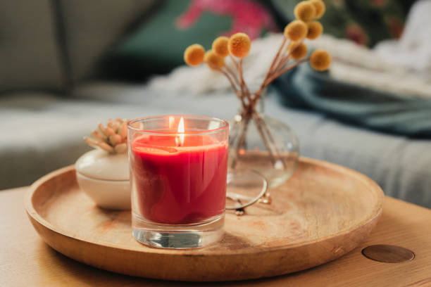 Scented candle burning on sofa table | Fab.ng
